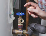Drain a couple of gallons of water from the water heater once or twice a year.